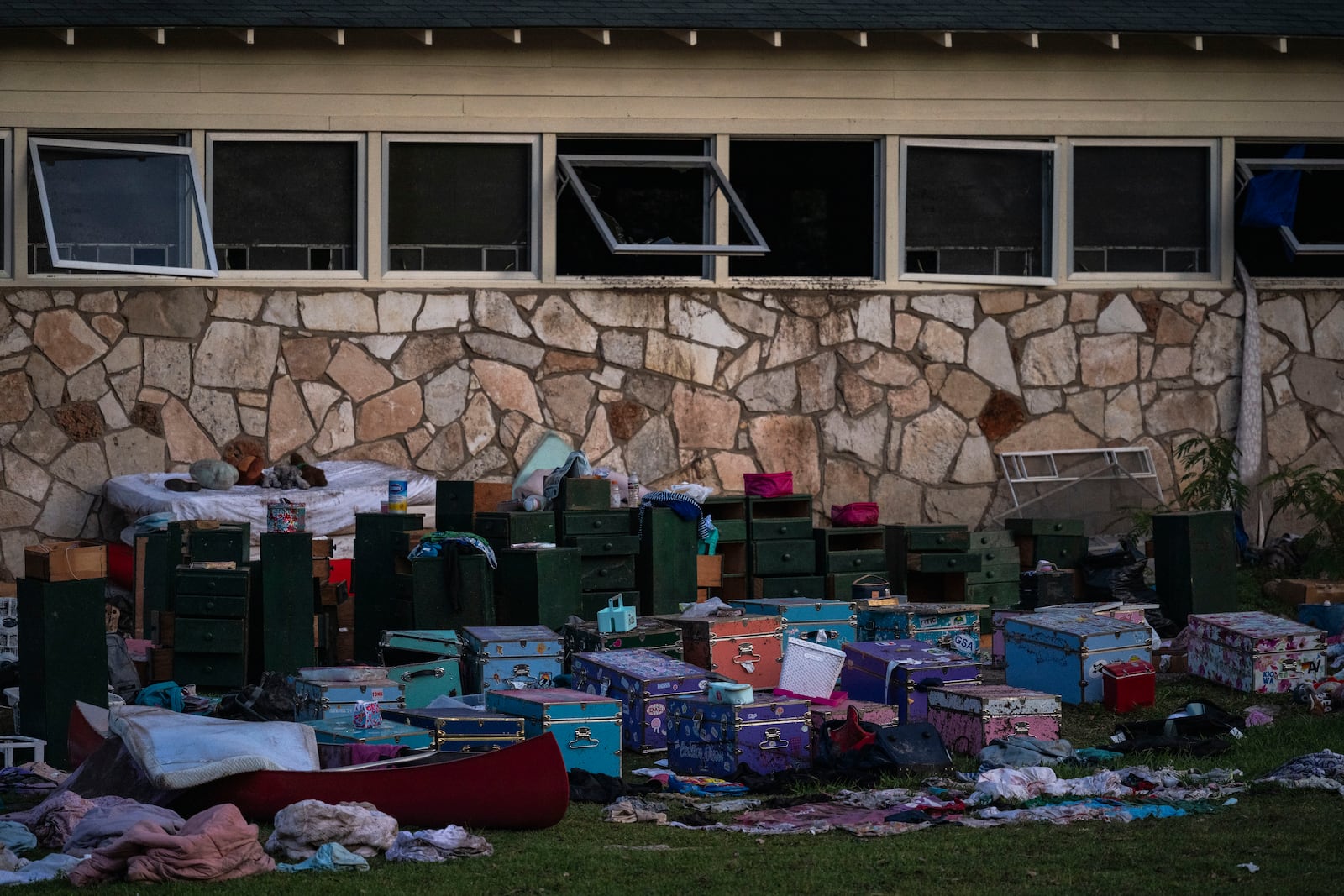 Camper's belongings sit outside one of Camp Mystic's cabins near the Guadalupe River after a flash flood swept through the area Monday, July 7, 2025, in Hunt, Texas. (AP Photo/Eli Hartman)