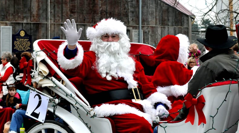 Santa and Mrs. Claus wave from their carriage as they ride in the Lebanon Carriage Parade. FILE PHOTO
