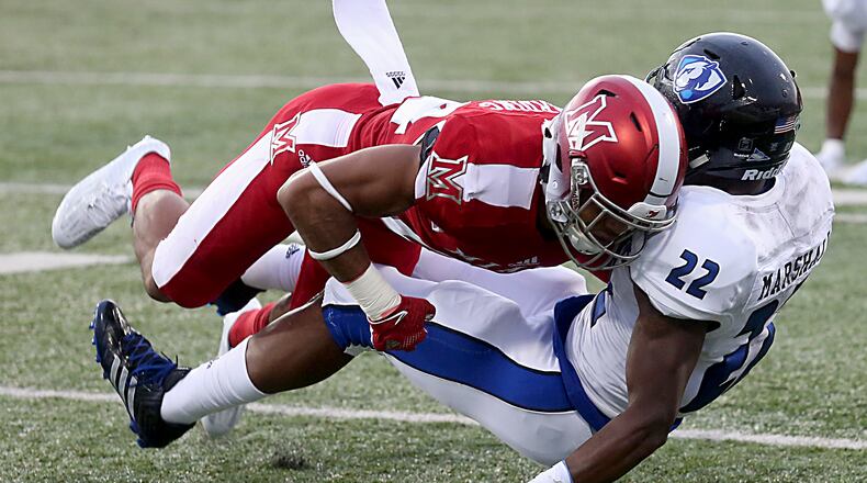 Contributed photo by E.L. Hubbard Miami cornerback Heath Harding puts a hit on Eastern Illinois running back Korliss Marshall during their game at Yager Stadium in Oxford Saturday, Sept. 10, 2016.