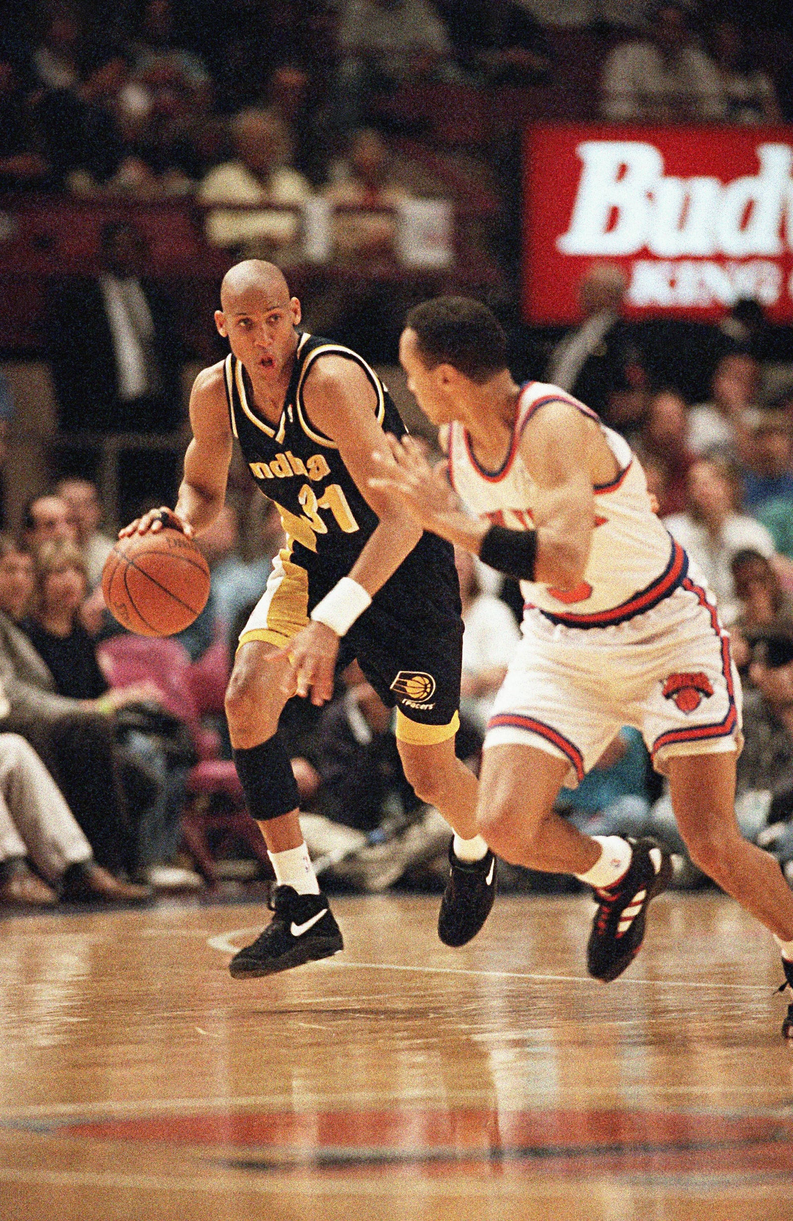 FILE - Indiana Pacers guard Reggie Miller, left, brings the ball down court while covered by New York Knicks guard John Starks during the first half of their NBA Eastern Conference Semifinals playoff game at New York's Madison Square Garden Sunday, May 7, 1995. (AP Photo/L.M. Otero, File)