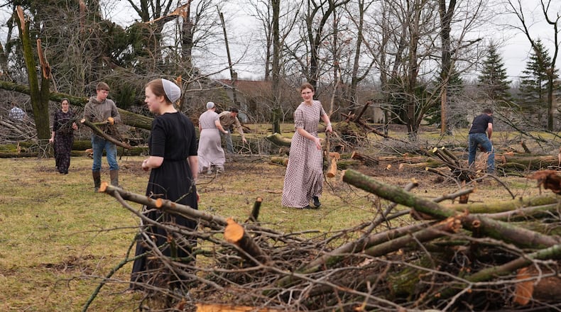 Volunteers work to clear branches after a suspected tornado hit the area a day earlier in Union City, Mich., Saturday, March 7, 2026. (AP Photo/Nam Y. Huh)