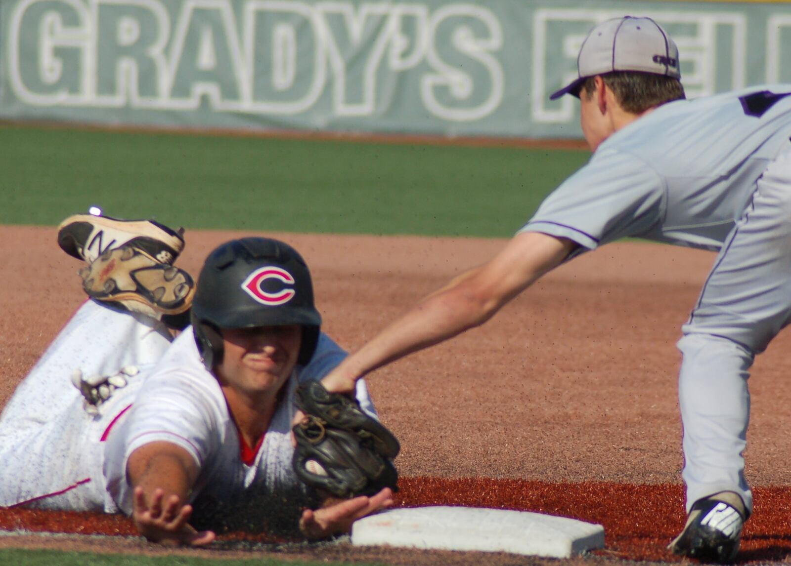 Carlisle’s Jake Glover is called out as he slides into third base Friday during a Division III regional final against Cincinnati Hills Christian Academy at the Athletes in Action complex in Xenia. That’s CHCA’s Jack Vezdos making the tag. CONTRIBUTED PHOTO BY JOHN CUMMINGS