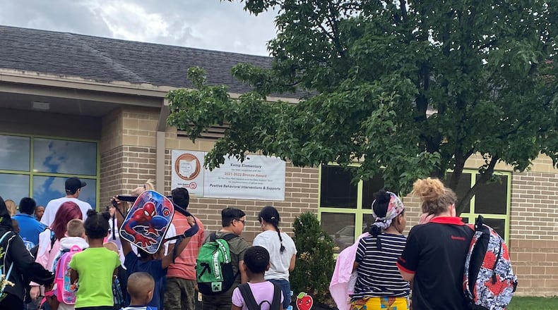 Kids and parents lined up before the first day of school started at Kemp Elementary, part of Dayton Public Schools, on Monday, Aug. 14, 2023. Eileen McClory / Staff