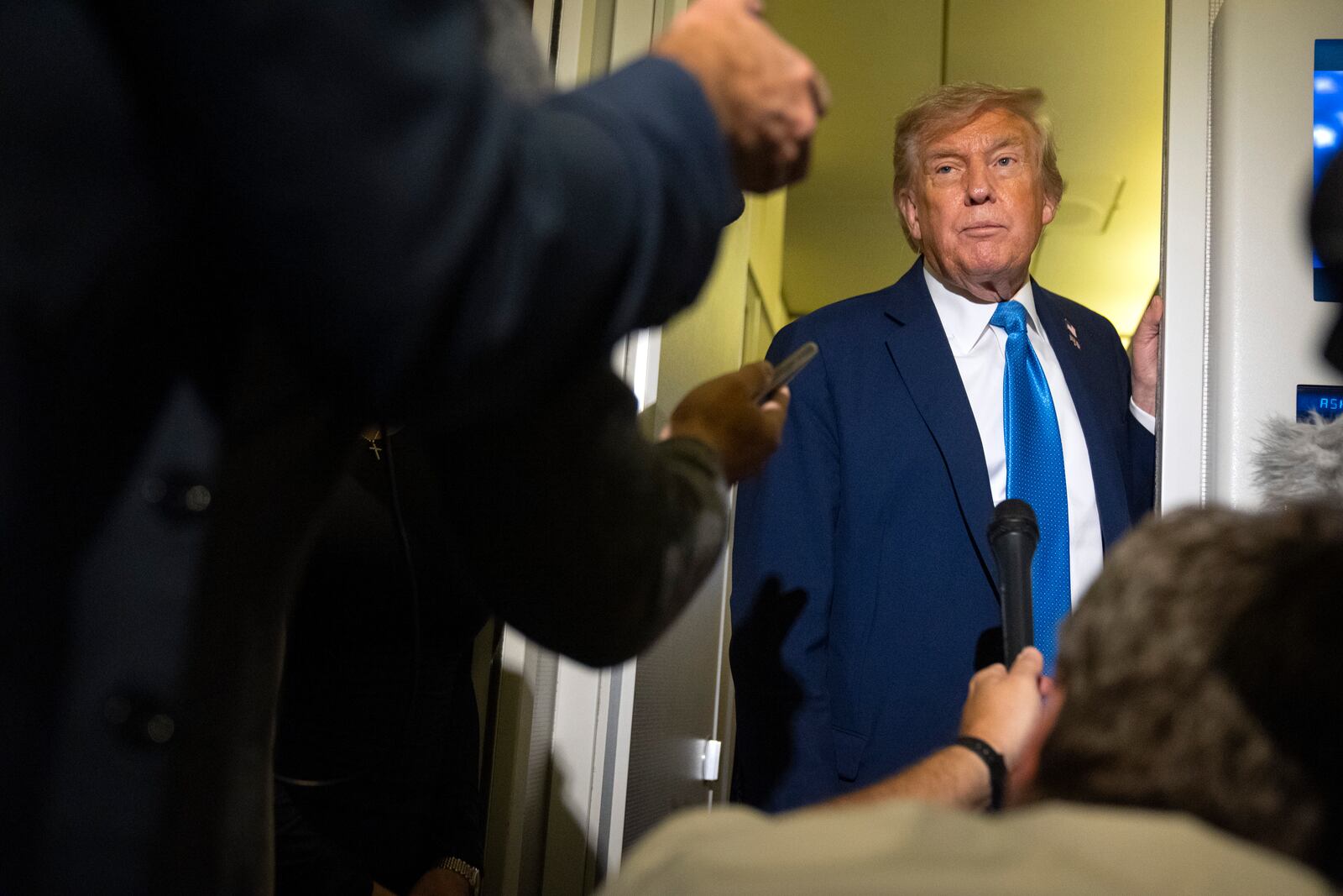 President Donald Trump speaks with reporters while flying aboard Air Force One en route from Calgary, Canada to Joint Base Andrews, Md., late Monday, June 16, 2025. (AP Photo/Mark Schiefelbein)