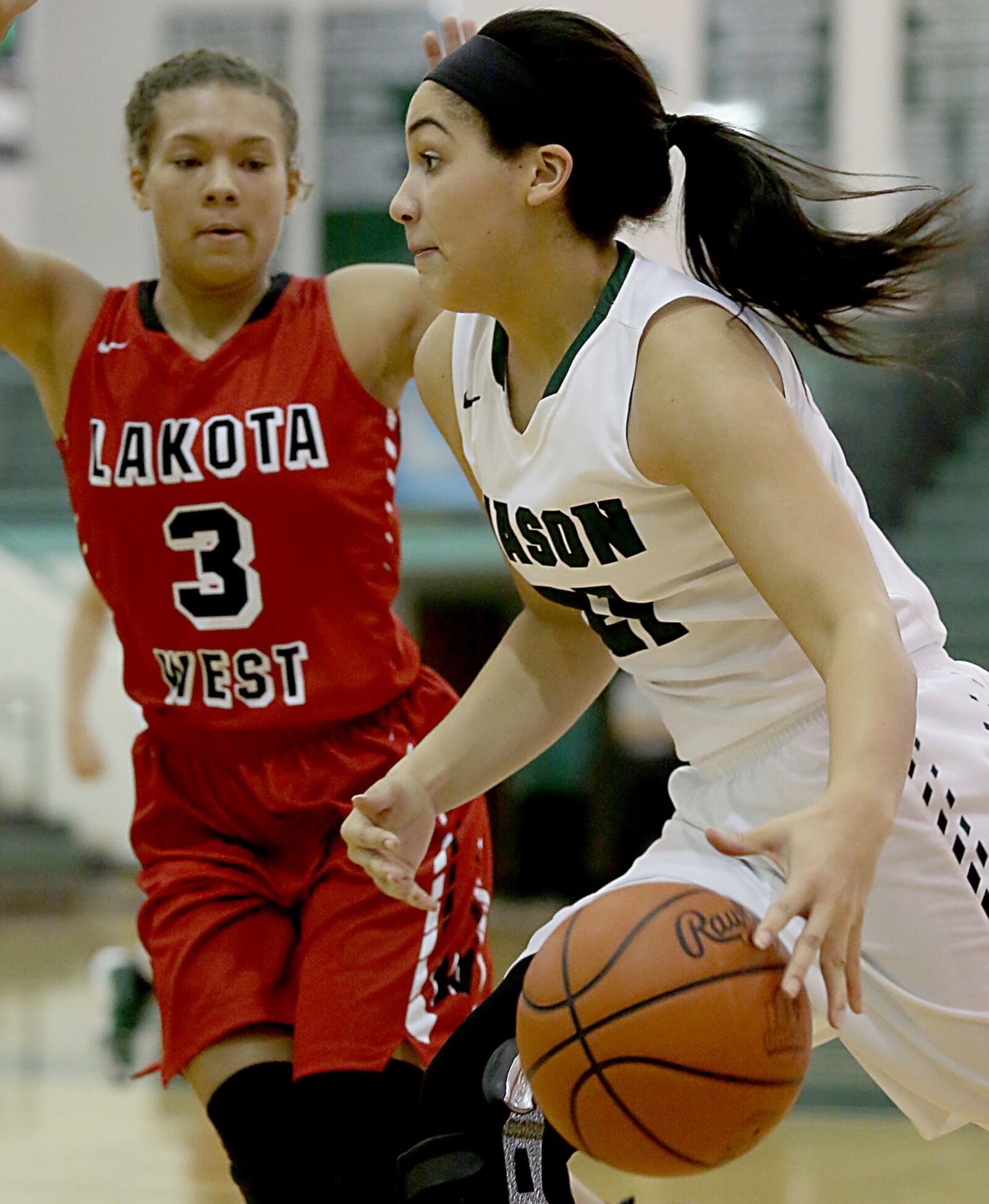 Mason’s Makenzie Dixon drives to the basket past Lakota West’s Juliauna Howard on Saturday afternoon at the Mason Arena. CONTRIBUTED PHOTO BY E.L. HUBBARD