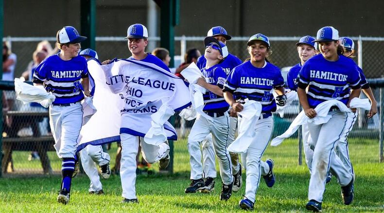 The Hamilton West Side Little League team celebrates its District 9 12-year-old baseball championship. The locals will begin state tournament play in Maumee on Sunday. NICK GRAHAM/STAFF