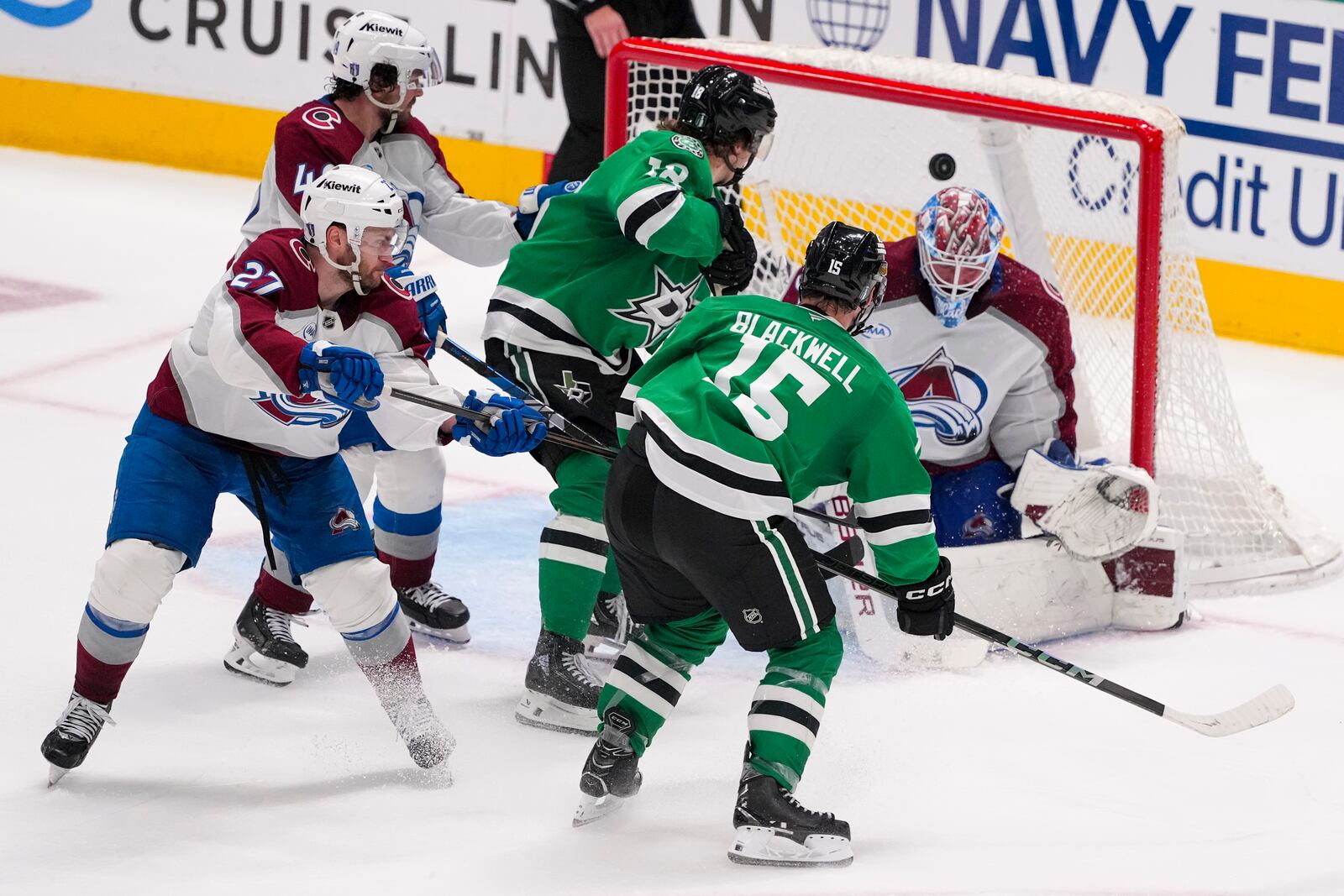 A shot by Dallas Stars center Colin Blackwell (15) gets by Colorado Avalanche goaltender Mackenzie Blackwood, right, for the game-winning goal during overtime in Game 2 of a first-round NHL hockey playoff series early Tuesday, April 22, 2025, in Dallas. (AP Photo/Julio Cortez)