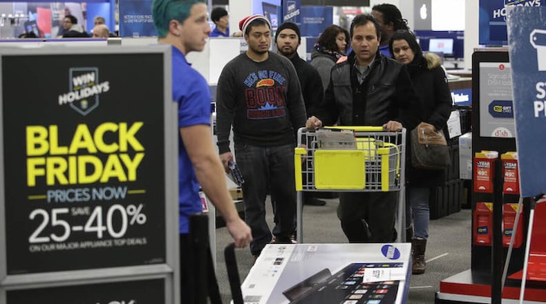 Customers shop for electronics and other items at a Best Buy on Nov. 27, 2015 in Skokie, Illinois. JOSHUA LOTT/WCPO