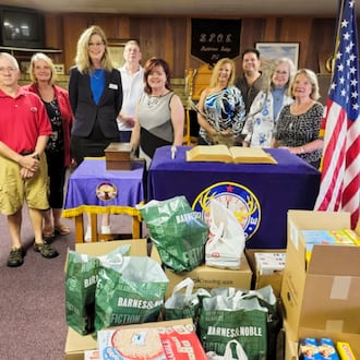 In 2021, the Middletown Elks Lodge #257 purchased books and board games for the Blue Star Families chapter that serves Southwest Ohio. The books and board games are given to local military families. Pictured left to right are Bret Frank, Karen Frank, Geri Maples, PhD/Chapter Director of Blue Star Families, John Ramsey, Melodie Rickard, Angie Whitt Sberna, Jim Sberna, Linda Jordan and Connie Back. Contributed.