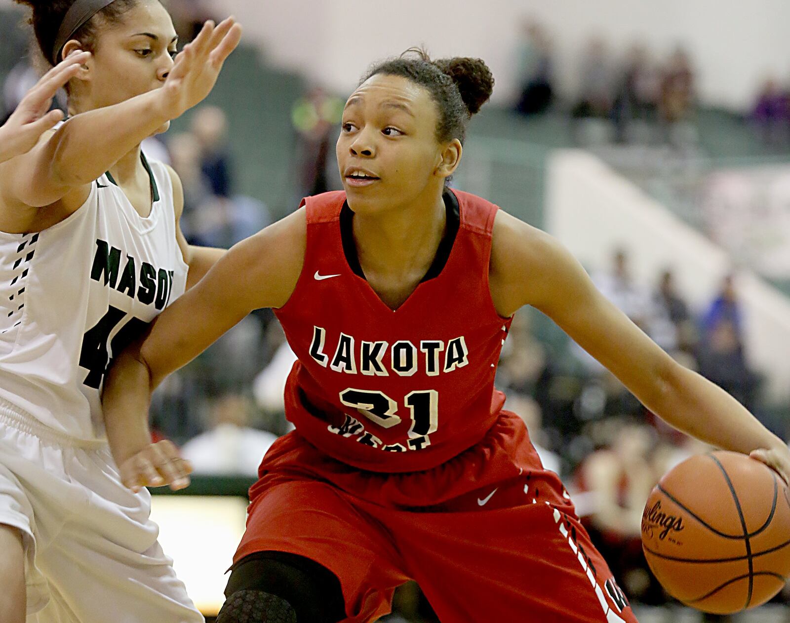 Lakota West’s Nevaeh Dean is defended by Mason’s Tihanna Fulton during their game at the Mason Arena on Saturday afternoon. CONTRIBUTED PHOTO BY E.L. HUBBARD