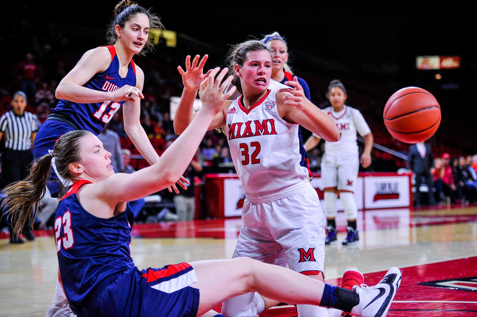 Miami University’s Savannah Kluesner (32) and Duquesne’s Helmi Tulonen (23) battle for the ball during Thursday night’s WNIT game at Millett Hall in Oxford. NICK GRAHAM/STAFF