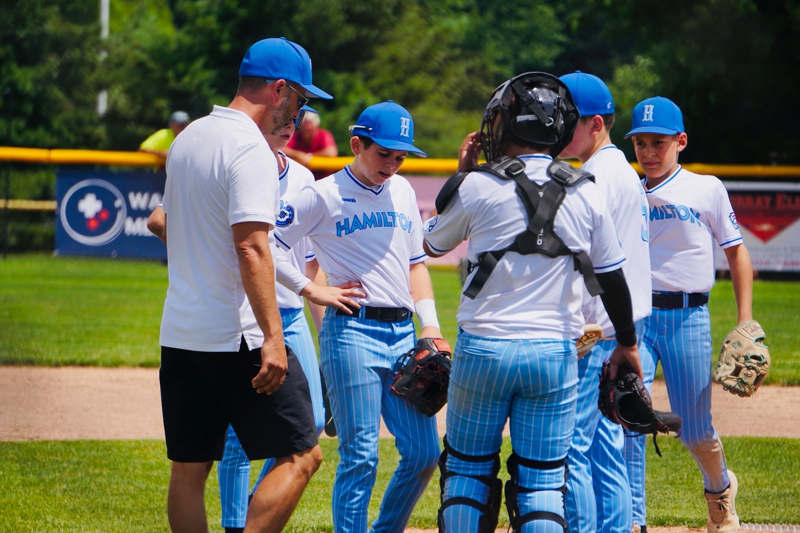 West Side Little League manager Ken Coomer chats with his players. West Side defeated Boardman 13-4 on Sunday to advance in the Ohio Little League state tournament at Boardman's Field of Dreams. CHRIS VOGT / CONTRIBUTED
