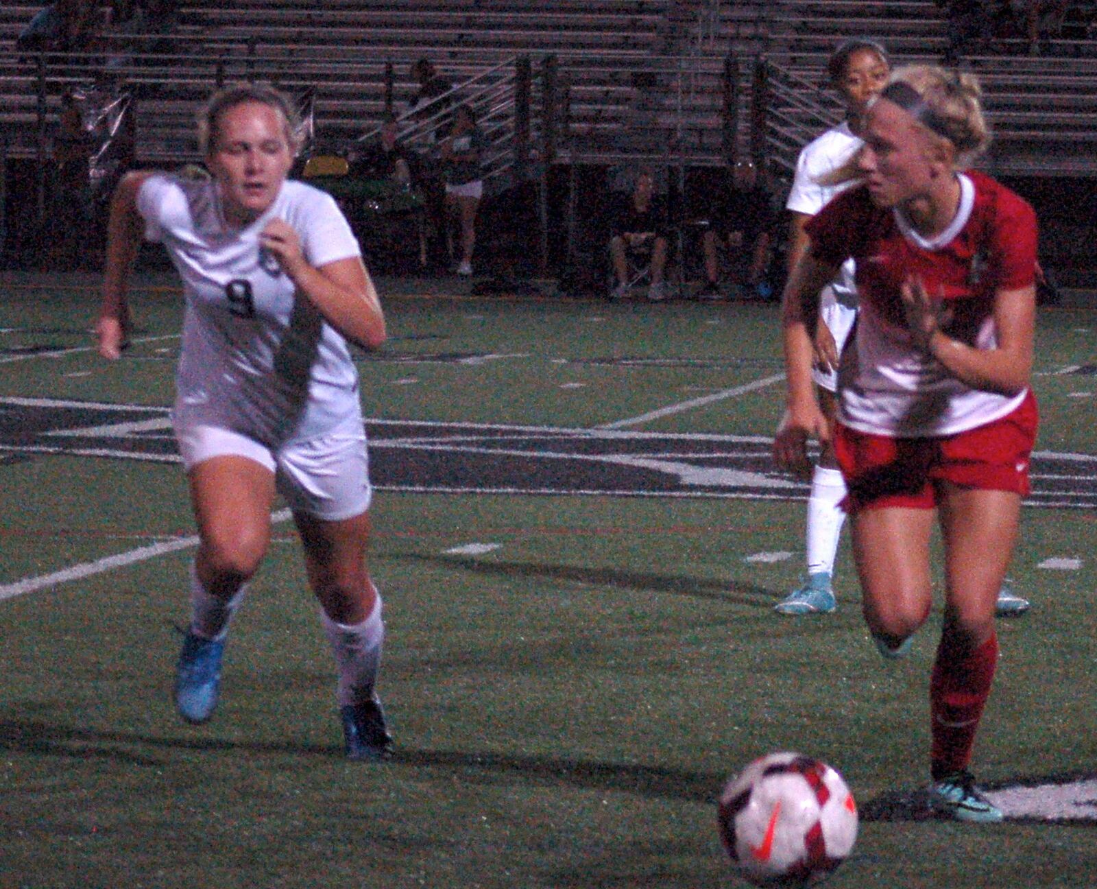 Fairfield’s Shelby O’Leary (right) looks to push the ball up the pitch as Lakota East’s Lexi Doherty moves in to apply pressure Tuesday night at East. CONTRIBUTED PHOTO BY JOHN CUMMINGS