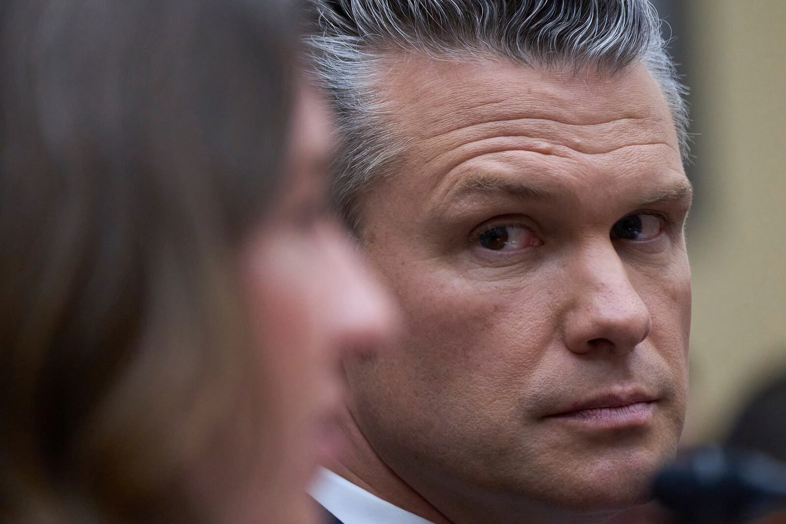 Secretary of Defense Pete Hegseth looks at Bryn MacDonnell, left, acting chief financial officer at the Department of Defense, as he fields questions on the Pentagon budget from the House Armed Services Committee, at the Capitol in Washington, Thursday, June 12, 2025. (AP Photo/J. Scott Applewhite)