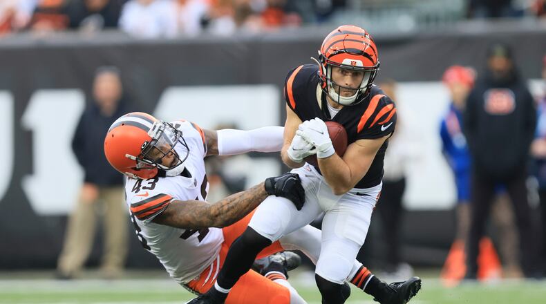 Cincinnati Bengals' Trent Taylor (11) runs out of a tackle of Cleveland Browns' John Johnson III (43) during the first half of an NFL football game, Sunday, Dec. 11, 2022, in Cincinnati. (AP Photo/Aaron Doster)