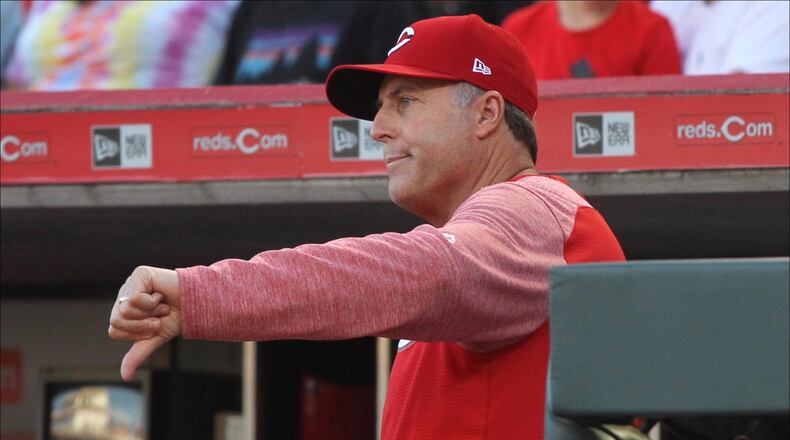 Reds manager Bryan Price motions to the umpires that he won't call for a review of a play at first base against the Brewers on Tuesday, June 27, 2017, at Great American Ball Park in Cincinnati. David Jablonski/Staff