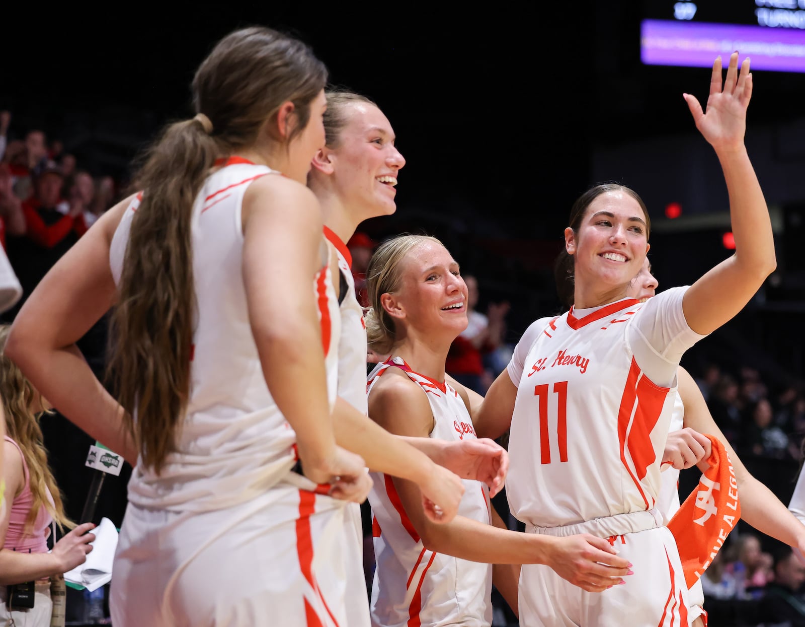 St. Henry senior guard Olivia Gast (far left) waves to fans in the final seconds of a 53-34 win over Canton Central Catholic in the Division VI state final on Friday, March 13 at University of Dayton Arena. BRYANT BILLING / STAFF