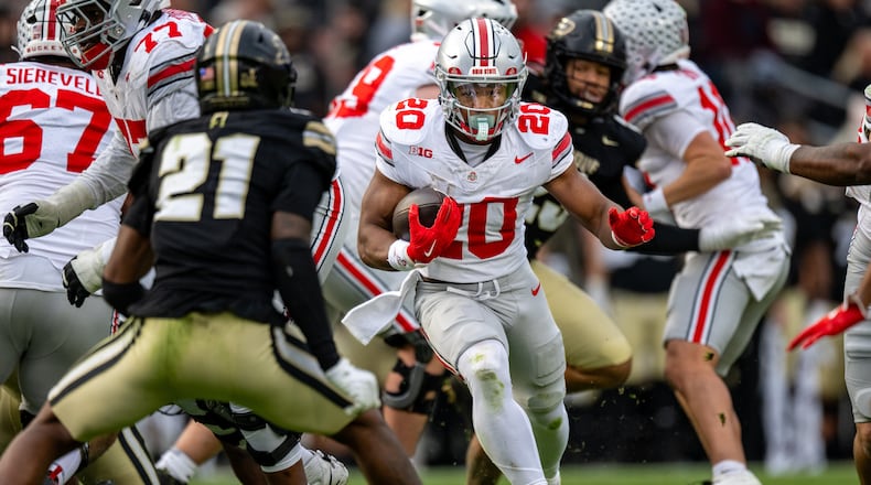 Ohio State running back James Peoples (20) carries the ball as Purdue defensive back Tahj Ra-El (21) closes in during the second half of an NCAA college football game, Saturday, Nov. 8, 2025, in West Lafayette, Ind. (AP Photo/Doug McSchooler)