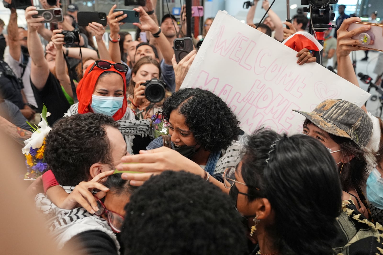 Mahmoud Khalil, left, is greeted by supporters upon arriving at Newark International Airport, Saturday, June 21, 2025, in Newark, N.J. (AP Photo/Seth Wenig)