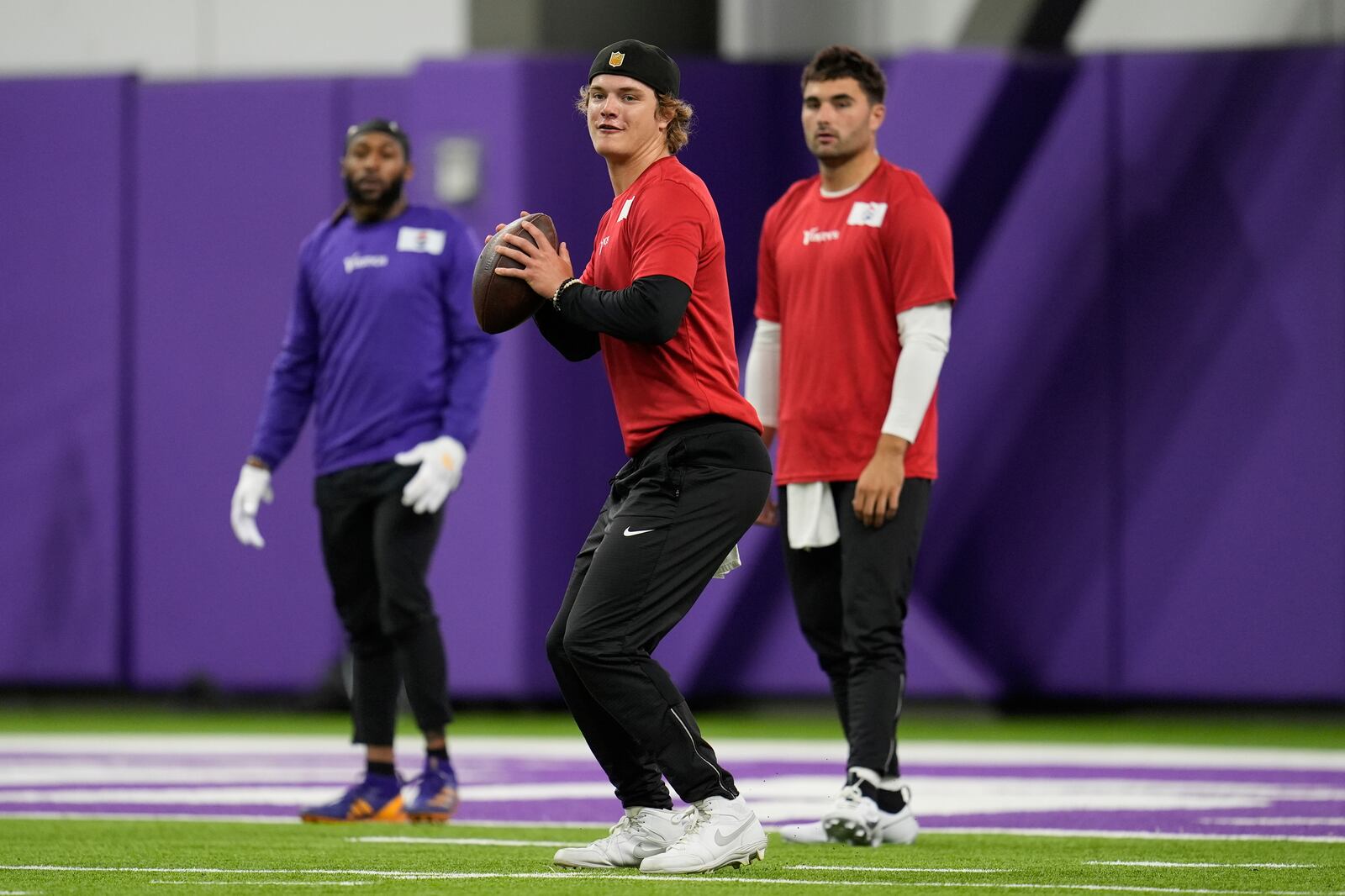 Minnesota Vikings quarterback J.J. McCarthy (9), center, takes part in drills during an NFL football team practice in Eagan, Minn., Tuesday, April 29, 2025. (AP Photo/Abbie Parr)