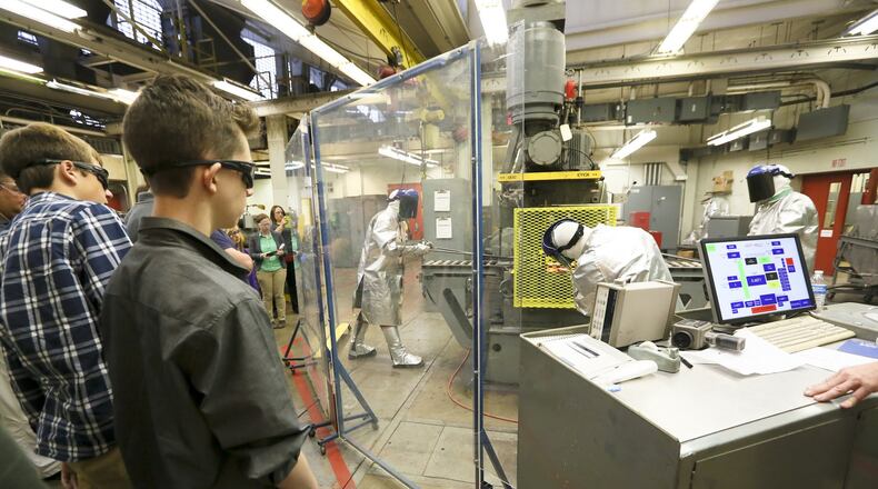 Students from Middletown and Monroe high schools listen to AK Steel research engineer Grant Thomas after viewing a hot rolling process demonstration as part of Manufacturing Day in 2015. GREG LYNCH / STAFF