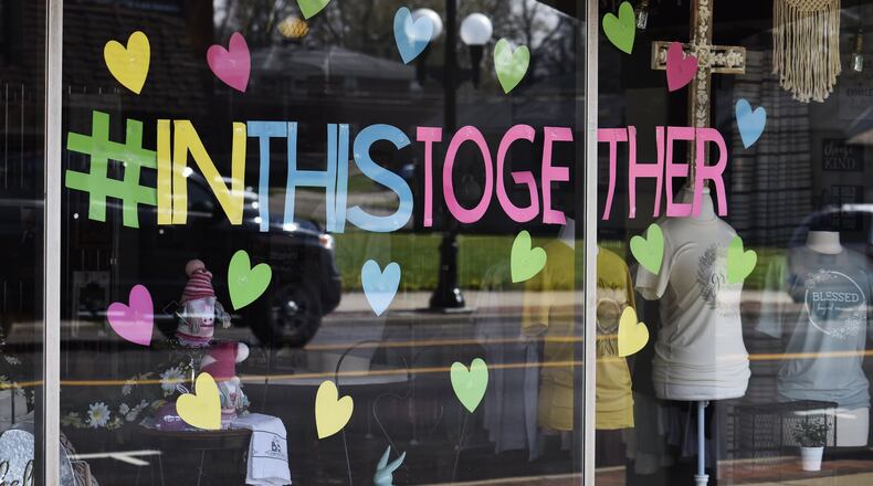 Scattering Joy Craft Boutique on Main Street in Hamilton is one of the businesses concerned the city government plans to buy their building for another development, forcing them to move elsewhere. In April of 2020, the business put hearts on its windows like many businesses in Butler County showing support for the community during the coronavirus pandemic. One way the business survived the pandemic was by making masks to protect people from COVID-19. NICK GRAHAM/STAFF