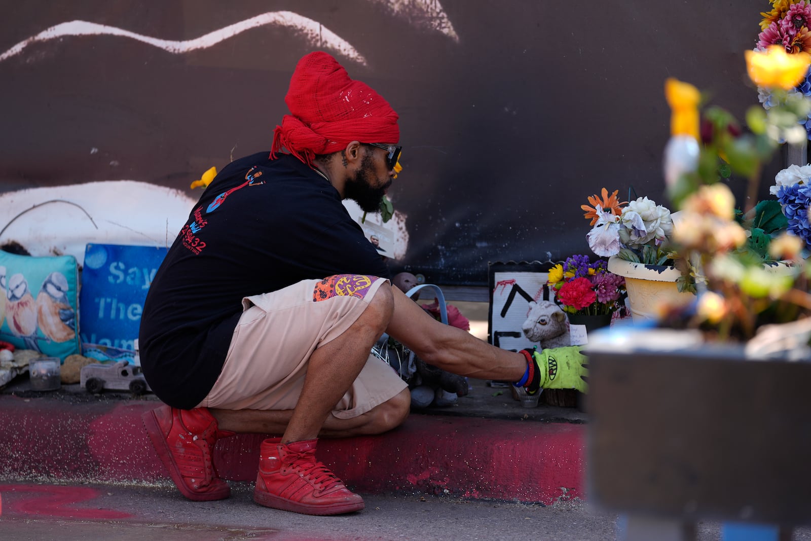 A person visits the spot of George Floyd's murder at George Floyd Square on the five-year anniversary of Floyd's death, Sunday, May 25, 2025, in Minneapolis. (AP Photo/Abbie Parr)