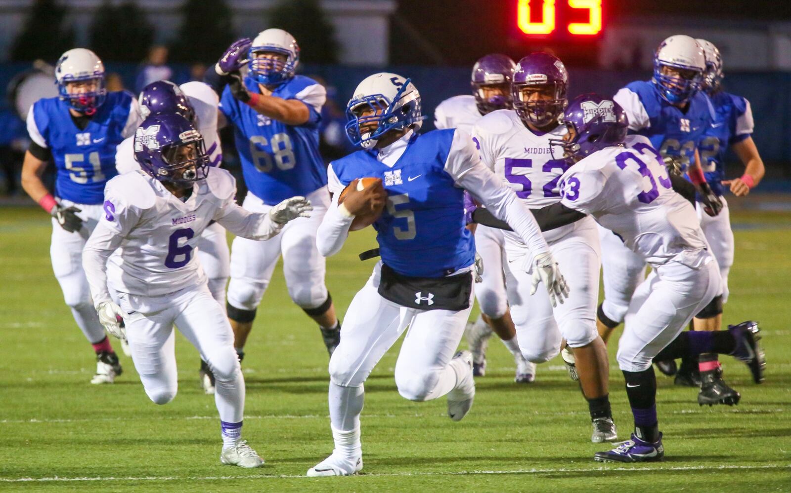 Hamilton quarterback Eric Jackson (5) looks for room to run during their game against Middletown at Virgil Schwarm Stadium in Hamilton on Oct. 21, 2016. GREG LYNCH/STAFF