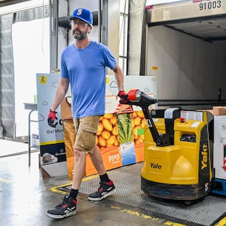 Craig Burns, an employee of Foodbank Inc., unloads a skid of watermelons on Wednesday, July 9. Thousands of Ohioans could lose eligibility for food assistance over the next few years under the new federal budget. BRYANT BILLING / STAFF