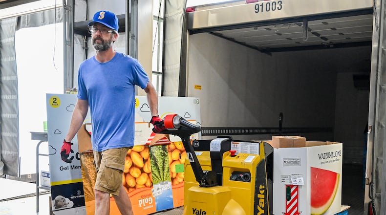 Craig Burns, an employee of Foodbank Inc., unloads a skid of watermelons on Wednesday, July 9. Thousands of Ohioans could lose eligibility for food assistance over the next few years under the new federal budget. BRYANT BILLING / STAFF