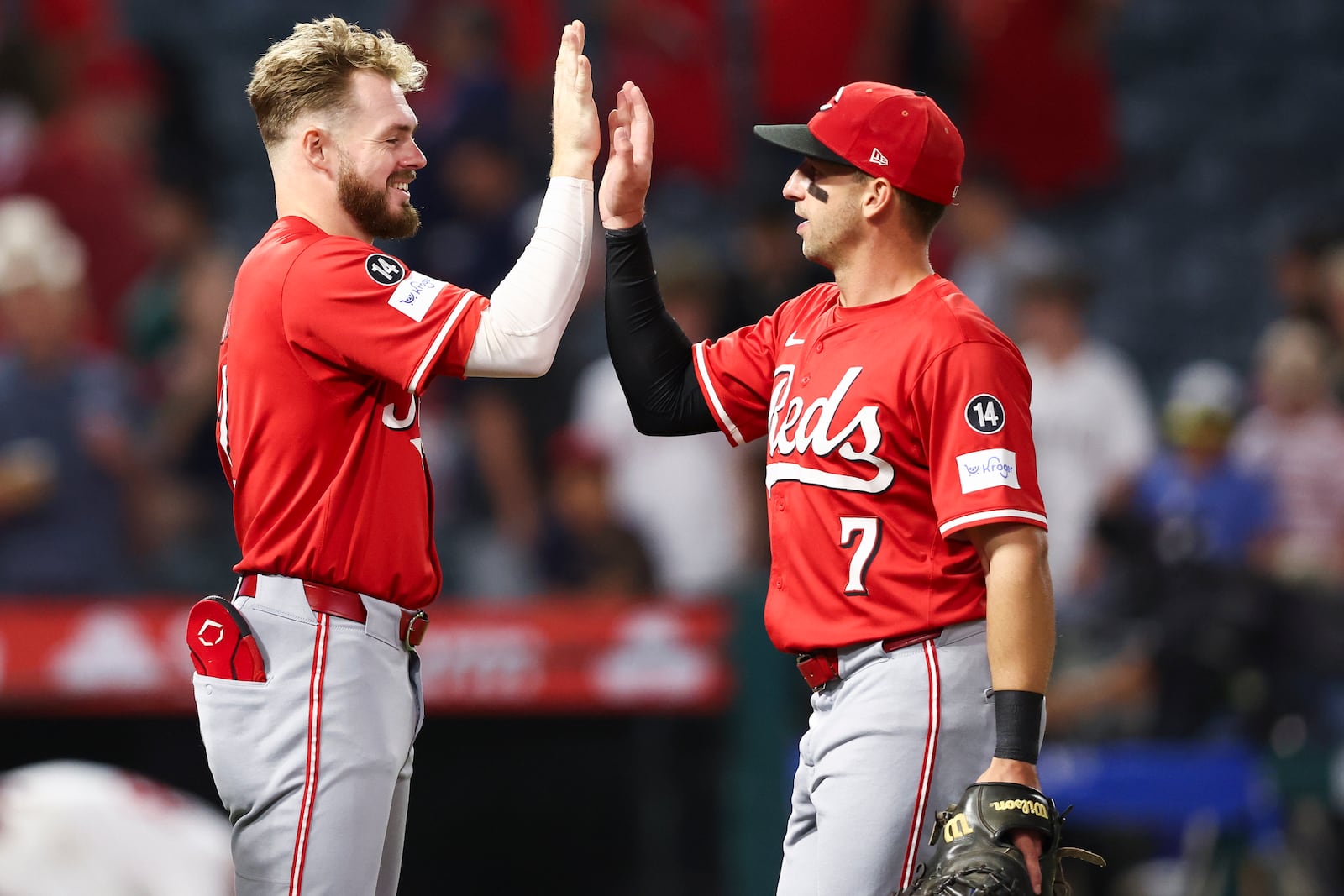 Cincinnati Reds' Gavin Lux, left, and first baseman Spencer Steer (7) celebrate after the Reds defeat the Angels in a baseball game, Monday, Aug. 18, 2025, in Anaheim, Calif. (AP Photo/Jessie Alcheh)