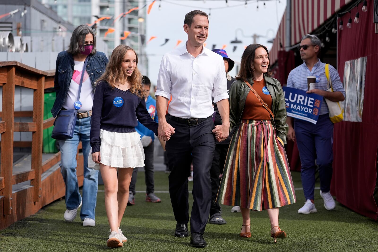 FILE - San Francisco mayoral candidate Daniel Lurie, middle, walks with his daughter Taya Lurie, foreground left, and his wife, Becca Prowda, foreground right, while campaigning in San Francisco, Saturday, Oct. 26, 2024. (AP Photo/Jeff Chiu, File)