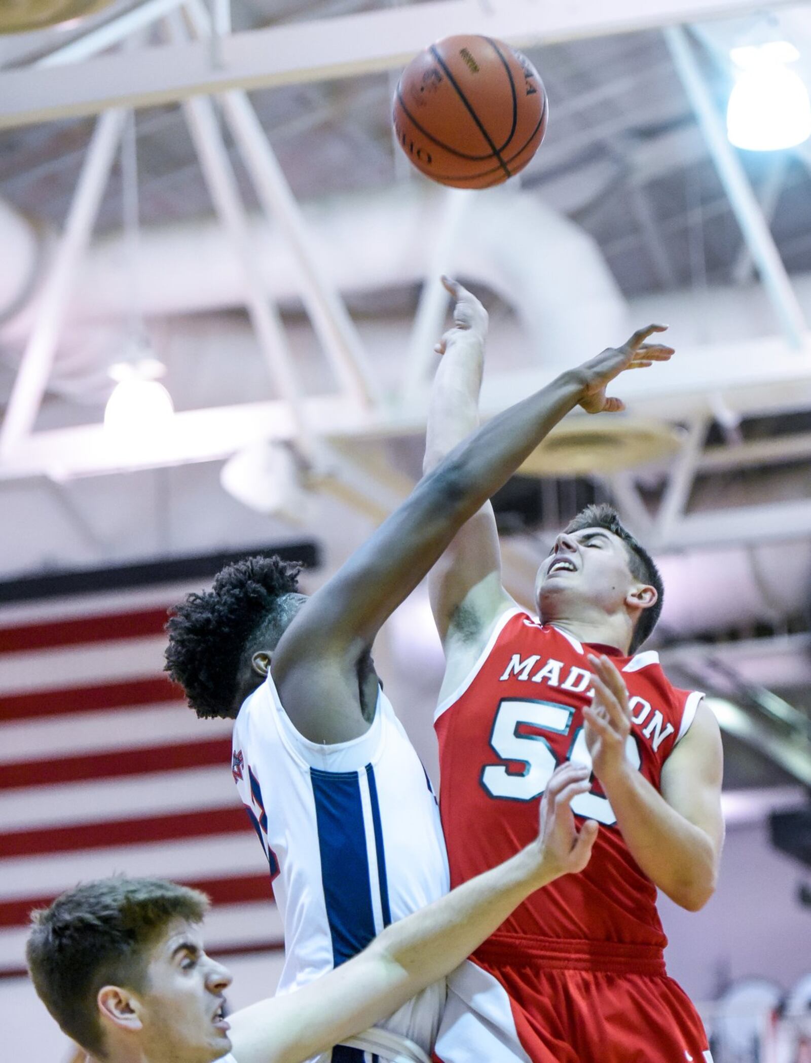 Miami Valley’s Lennox Roberts defends a shot by Madison’s Tyler Baumgartner during Thursday night’s Brian Cook Classic in Madison Township. NICK GRAHAM/STAFF
