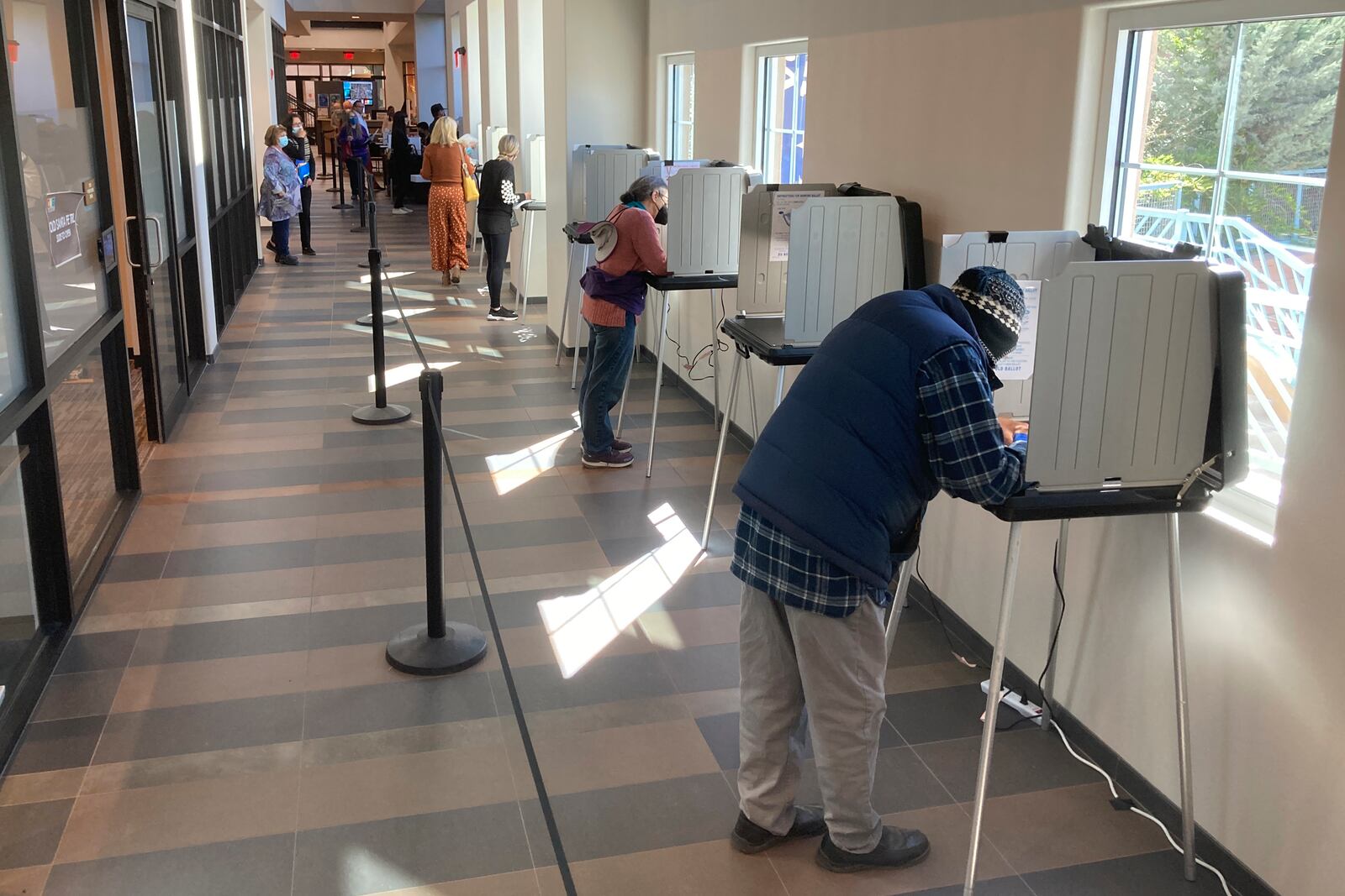 FILE - Santa Fe County, N.M., residents fill out general election ballots during the first day of general election voting, Oct. 11, 2022, in a hallway outside the Santa Fe County Clerk's Office in Santa Fe, N.M. (AP Photo/Morgan Lee, File)