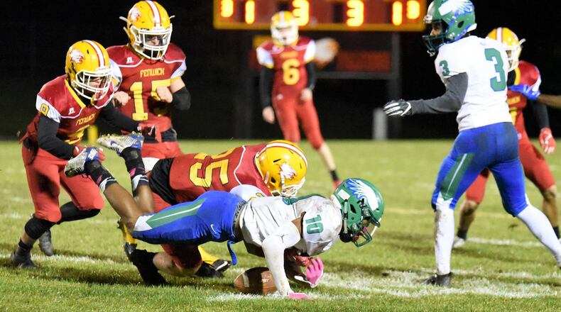 Fenwick’s David Schuh (25) forces a fumble by Chaminade Julienne’s Dominic Wilcox (10) and is about to recover the ball during Friday night’s Division III, Region 12 playoff game at Krusling Field in Middletown. Fenwick took a 28-7 win. CONTRIBUTED PHOTO BY ANGIE MOHRHAUS