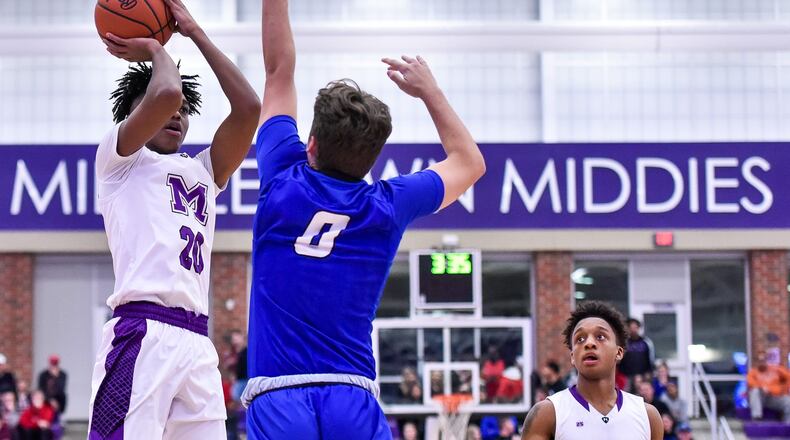 Middletown’s Johrdon Mumford puts up a shot over Hamilton’s Payton Pennington during their game Dec. 7, 2018, at Wade E. Miller Arena in Middletown. The host Middies won 64-56. NICK GRAHAM/STAFF