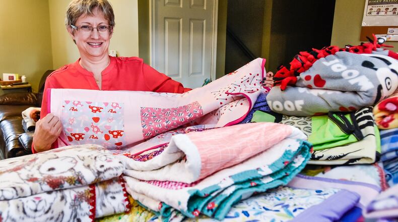 Kimberly Renner, of West Chester Twp., has started the Southwest Ohio Chapter of the Binky Patrol. Binky Patrol is a national nonprofit organization that makes and gives handmade blankets to babies born HIV positive or drug-addicted, children who are abused, in shelters, or foster care. Recipients are a day old to 18 years old. To join Binky Patrol a volunteer only need an open heart, a needle, some thread and a desire to help. No sewing experience is necessary. NICK GRAHAM/STAFF