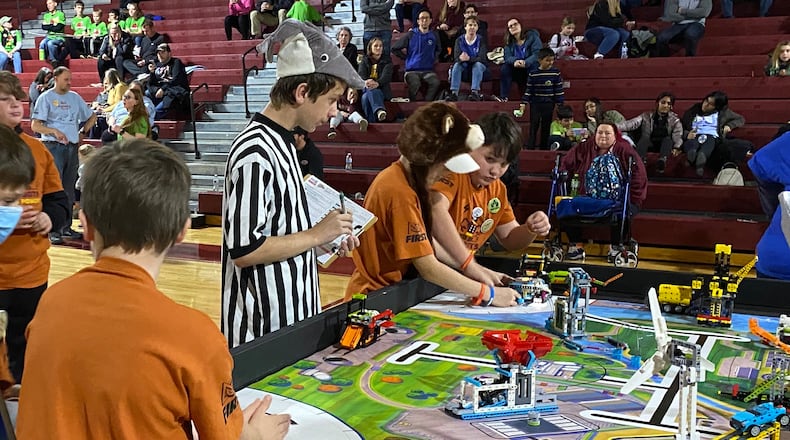 The Ross Schools’ tradition of student-produced robots battling and besting others will be tested as the district’s robotics team hosts a competition later this month. The top-rated academic school system in Butler County has for years also had a reputation for the successes of its student robotics squads, which often dominate other student teams in the region. Pictured are Ross students and their robot creations competing in last year’s competition. CONTRIBUTED