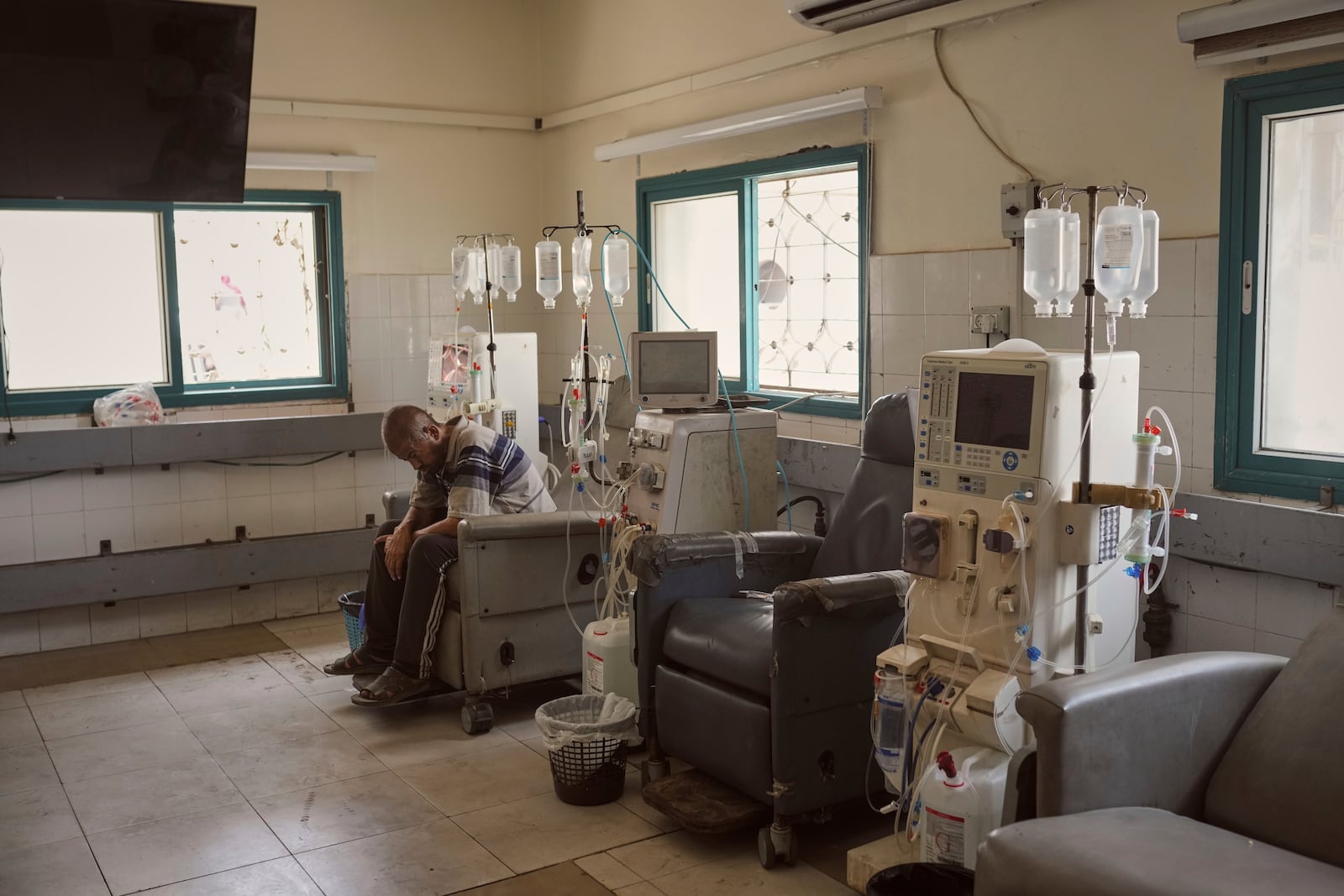 A patient sits in the dialysis unit at Shifa Hospital in Gaza City on Tuesday, July 1, 2025, after the facility suspended its services due to fuel shortages needed to power its generators. (AP Photo/Jehad Alshrafi)