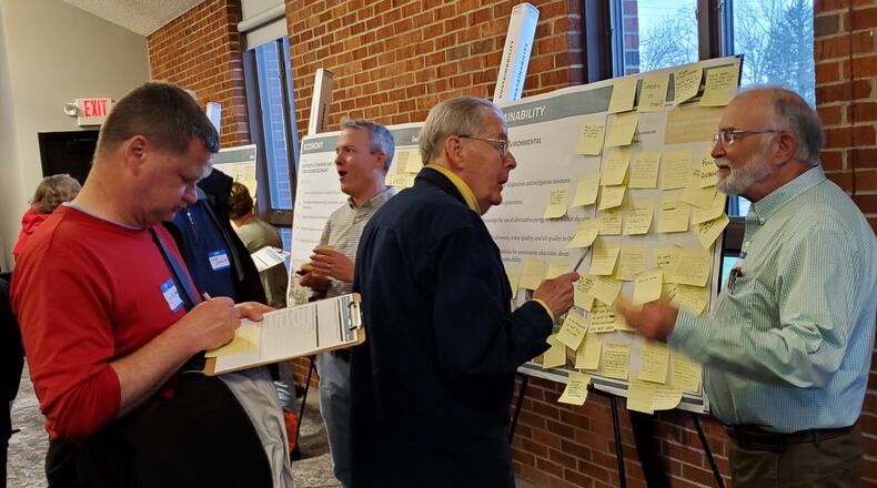 Steve Dana talks to Mark Boardman (right) about the sustainability issues posted on the board at Monday’s visioning workshop as the second public meeting in the development of an update for the city’s Comprehensive Plan. CONTRIBUTED/BOB RATTERMAN