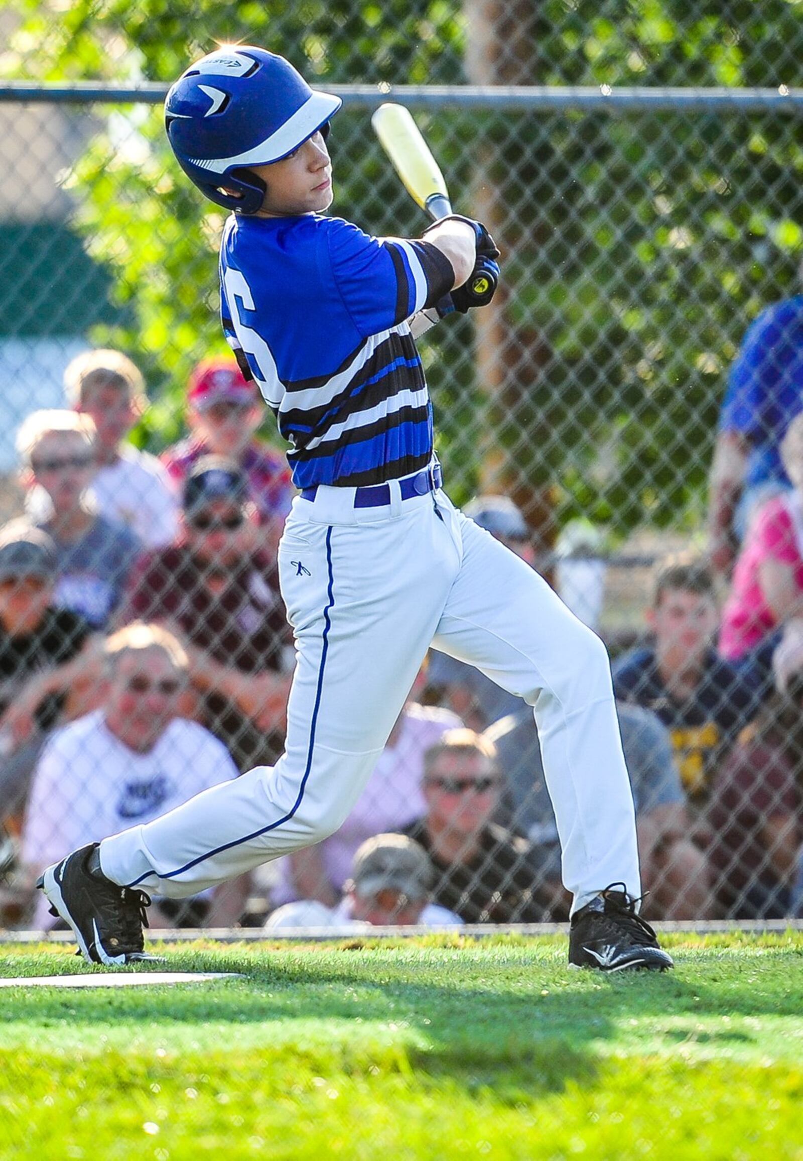 Hamilton West Side Little League’s Lake Cundiff launches a home run during their District 9 tournament championship win over Lebanon on Monday at West Side. NICK GRAHAM/STAFF