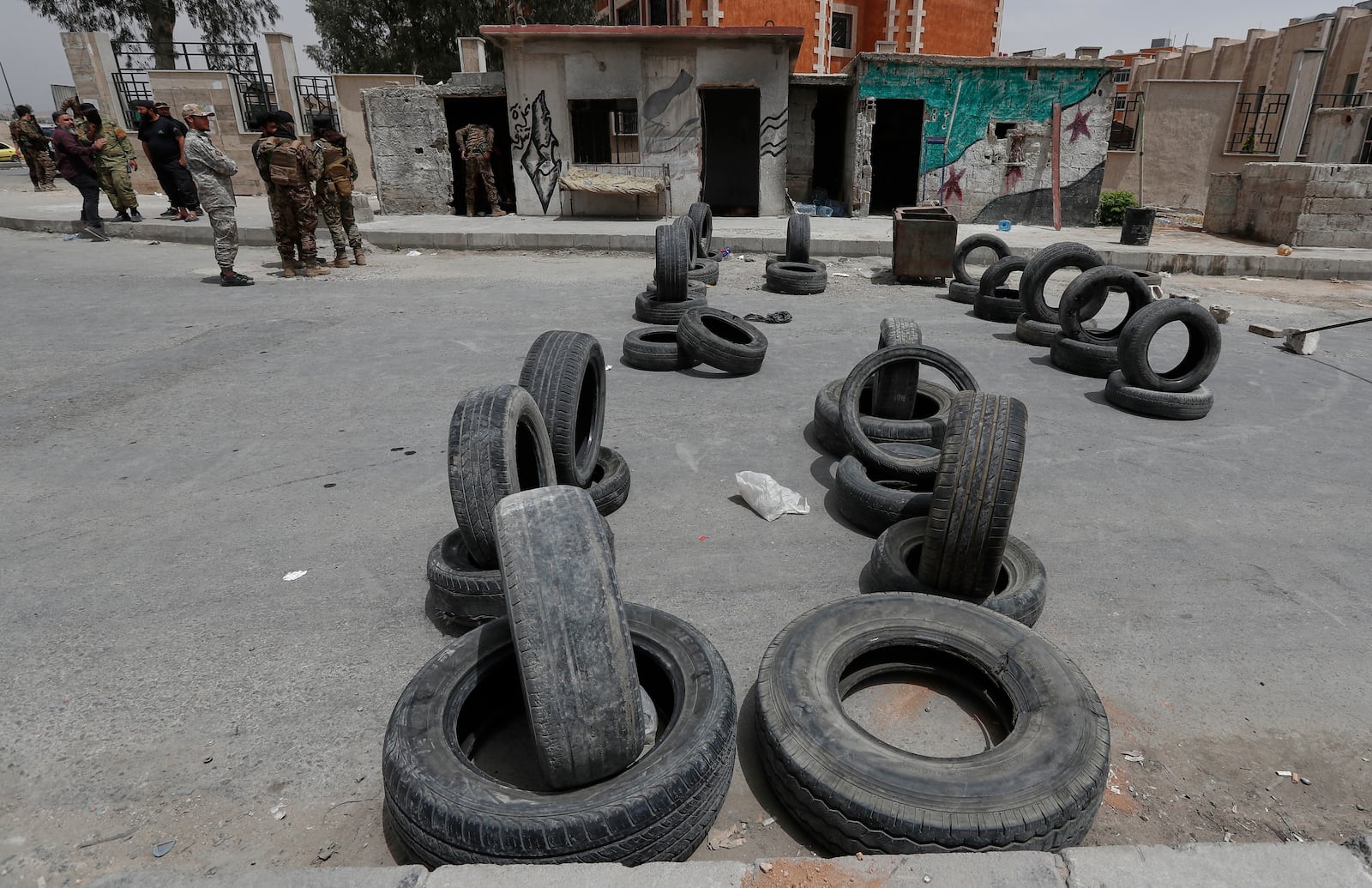 Syrian government security forces stand guard on their checkpoint at one of Jaramana suburb entrances, after clashes in the area between members of the minority Druze sect and pro-government fighters, in the southern suburb of Jaramana, Damascus, Syria, Wednesday, April 30, 2025. (AP Photo/Omar Sanadiki)