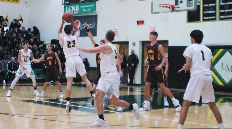 Little Miami’s Cole Spencer (23) puts up a shot over the Ross defense, which includes Max Stepaniak (34), during Friday night’s game at Little Miami. The host Panthers won 52-51. RICK CASSANO/STAFF