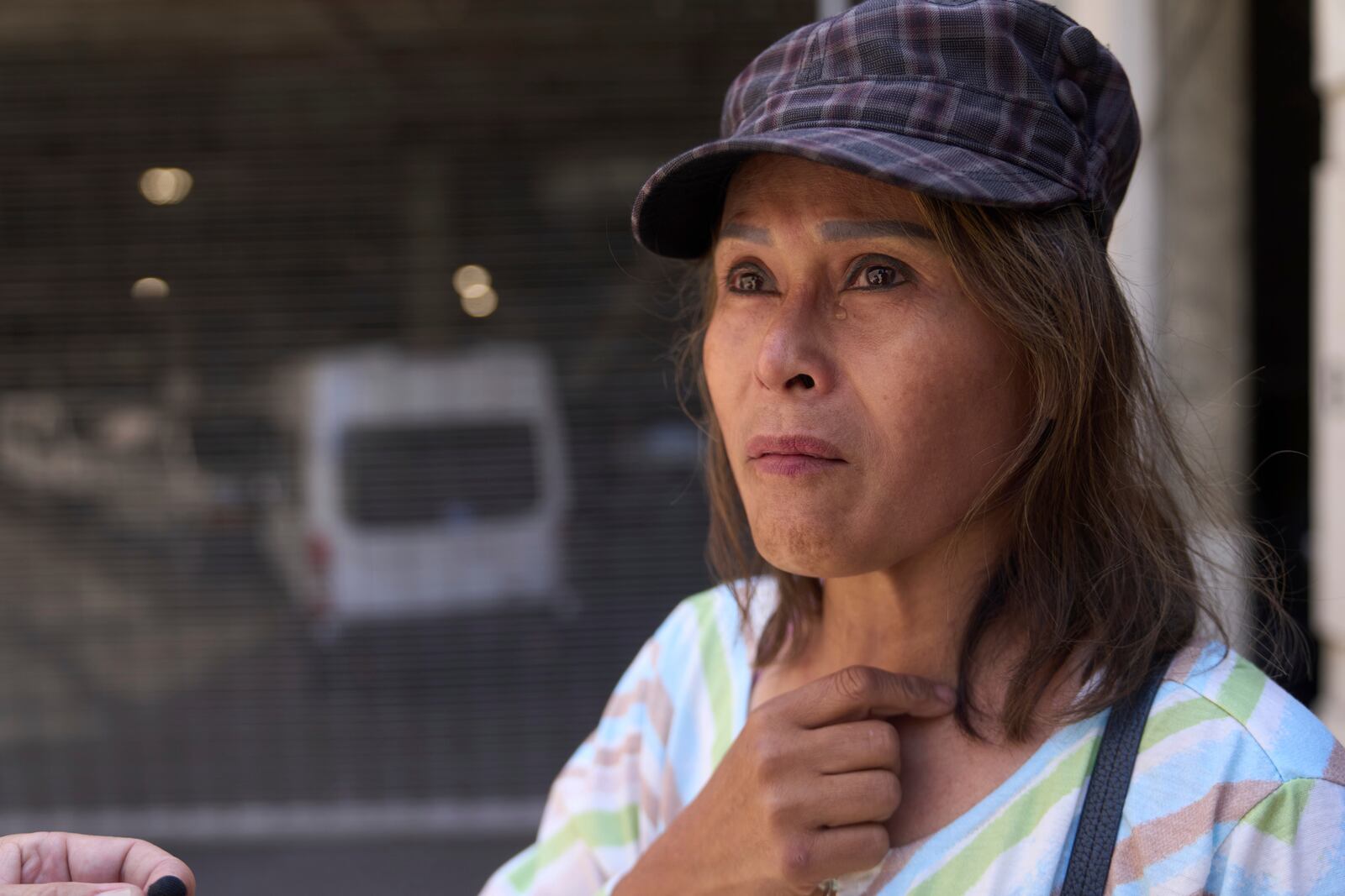 Som Xin, originally from Laos, stands outside the ICE Los Angeles Staging Facility looking to find a family member detained by federal agents in Los Angeles on Wednesday, June 25, 2025. (AP Photo/Damian Dovarganes)