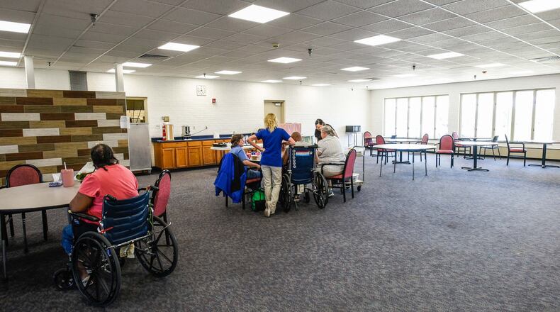 In April, residents play games in the partially renovated dining area at the Butler County Care Facility. Changes at the county-run nursing home are bringing about cost savings and increased revenues of almost $1 million, according to a county official. NICK GRAHAM/STAFF