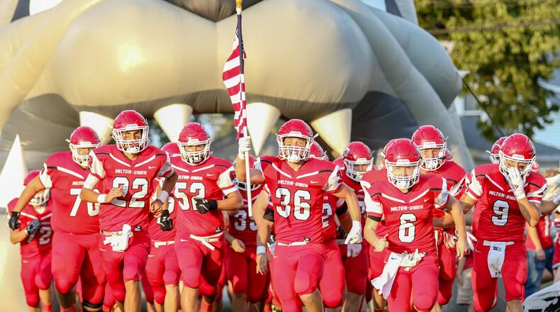 The Milton-Union High School football team runs out onto the field before its game against Northwestern on Sept. 13 at Memorial Stadium. CONTRIBUTED PHOTO BY MICHAEL COOPER