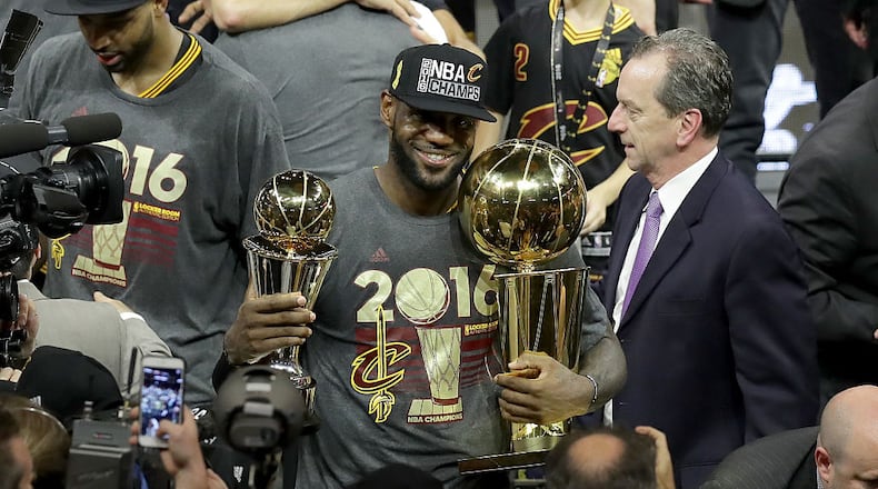 OAKLAND, CA - JUNE 19: LeBron James #23 of the Cleveland Cavaliers holds the Larry O'Brien Championship Trophy and the Bill Russell NBA Finals Most Valuable Player Award after defeating the Golden State Warriors 93-89 in Game 7 of the 2016 NBA Finals at ORACLE Arena on June 19, 2016 in Oakland, California. NOTE TO USER: User expressly acknowledges and agrees that, by downloading and or using this photograph, User is consenting to the terms and conditions of the Getty Images License Agreement. (Photo by Ronald Martinez/Getty Images)