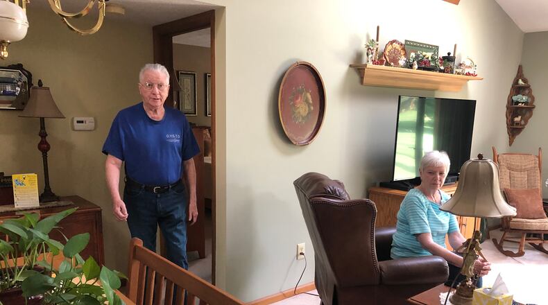 As part of his rehabilitation, Dave Campbell walks around his Lebanon home as his wife, Bev, keeps a close eye. Recovering from the coronavirus, Campbell walks about three fourths a mile daily. RICK McCRABB/STAFF