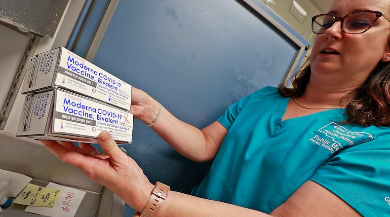 Kristen Earley, a nurse at the Clark County Combined Health District, shows some of the District's COVID vaccine as she sorts through the freezer Wednesday, June 21, 2023. BILL LACKEY/STAFF