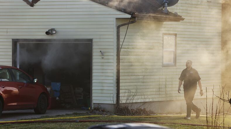 The Monroe Fire Department responded to a house fire Tuesday night on Sunset Court. One resident was transported to Atrium Medical Center with unknown injuries. NICK GRAHAM/STAFF